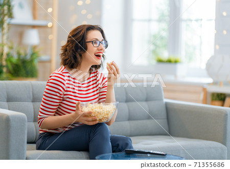 Young woman watching TV Young woman watching TV 71355686