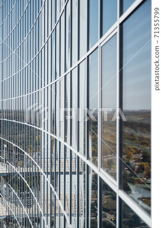 Facade of skyscraper. Many windows of geometric. Wall with lots of identical window rows Facade of skyscraper. Many windows of geometric. Wall with lots of identical window rows 71355799