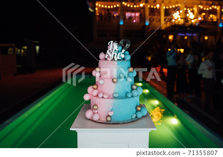 Big and delicious pink and blue baby gender reveal party cake 71355807