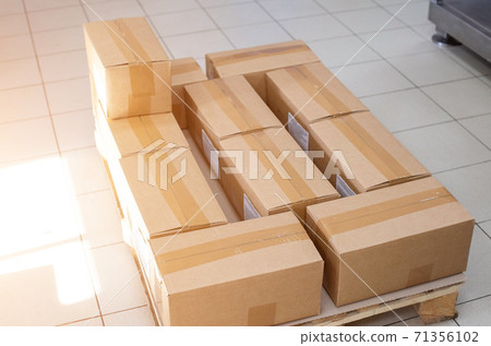 Pallet with cardboard boxes in production. The concept of cheap and durable cardboard packaging at a low cost 71356102