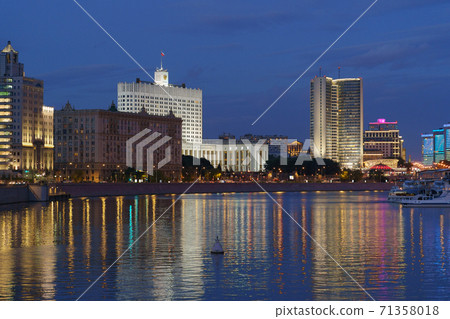 Moscow cityscape in summer night. Moskva River, touristic ship, residential and business buildings. House of the Government of the Russian Federation (Russian White House) on Krasnopresnenskaya emb. Moscow cityscape in summer night. Moskva River, touristic ship, residential and business buildings. House of the Government of the Russian Federation (Russian White House) on Krasnopresnenskaya emb. 71358018