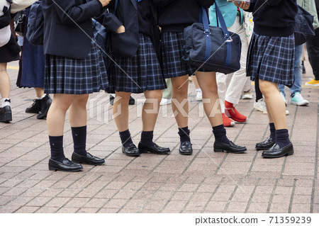The feet of a high school girl wearing short navy blue socks 71359239