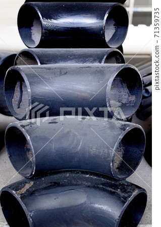 Black metal pipes and adapters of different diameters for gasification or water supply. Industrial background  71359735