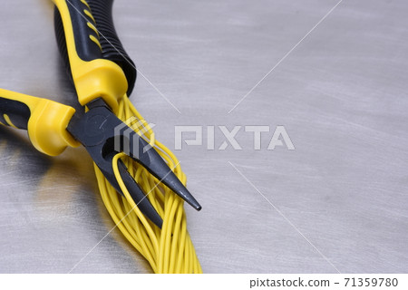 Electrical tools and cables on metal surface with place for text 71359780