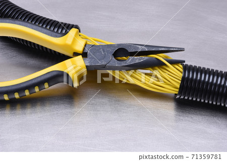 Electrical tools and cables on metal surface with place for text 71359781