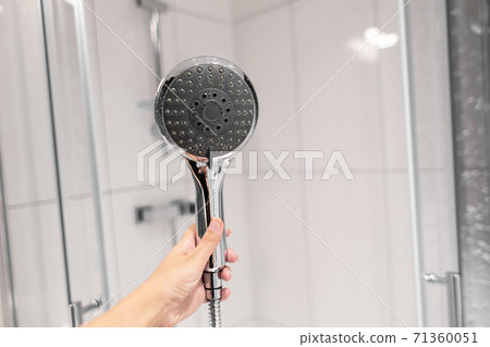 Chrome plated shower head, shower treatments. The girl takes a shower. Shower accessories 71360051