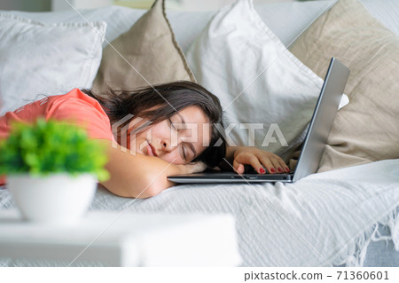 The girl fell asleep on a laptop while working. Sleep during working hours. Freelancer problems 71360601