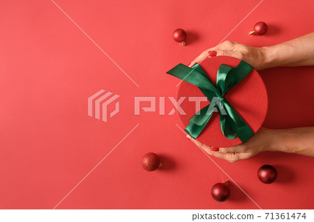 Christmas gift box in female hands. 71361474