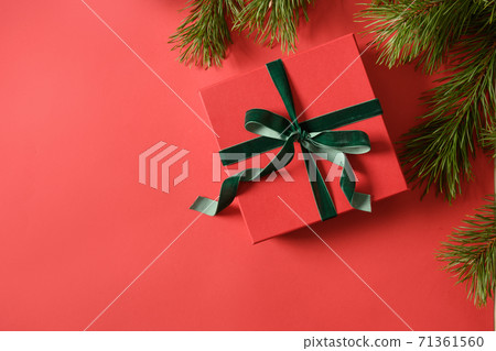 Christmas gift, red balls, evergreen branches.  71361560