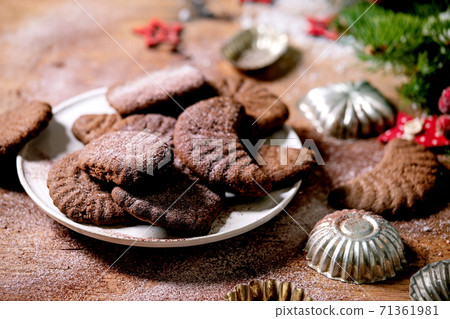 Christmas shortcrust cookies chocolate crescents with fir tree, molds, xmas decorations. 71361981