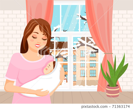 Mom holding in her arms a small baby is standing in the room. Baby in a tender embrace of mother 71363174