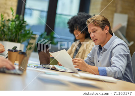 Two diverse coworkers working together in the modern office Two diverse coworkers working together in the modern office 71363177