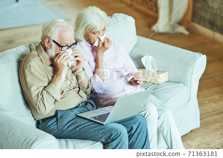 Gray-haired man and woman feeling sick at home Gray-haired man and woman feeling sick at home 71363181
