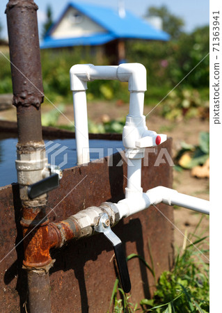 Plumbing from plastic pipes with a connection to a metal column. 71363941