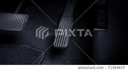 Close up images of man driving car by pushing accelerator and brake pedal with right foot black leather shoe and black jean pant. camera shot inside the japanese car. 71364655