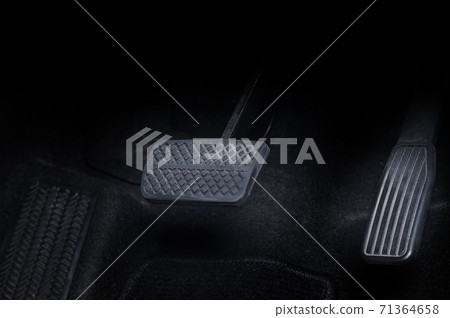 Close up images of man driving car by pushing accelerator and brake pedal with right foot black leather shoe and black jean pant. camera shot inside the japanese car. 71364658