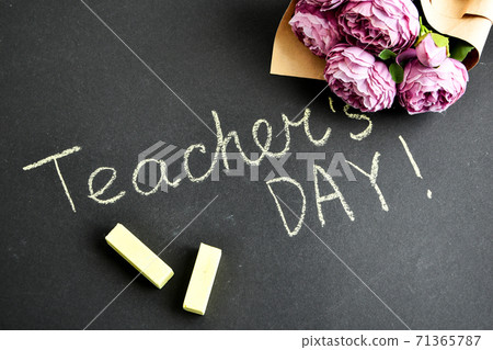 Flat lay composition with flowers peonies bouquet and inscription TEACHER'S DAY on black chalkboard 71365787