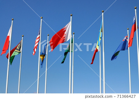 Flags of all over the world waving against a blue sky background Flags of all over the world waving against a blue sky background 71366427