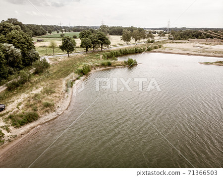 Aerial view of a path next to a gravel pond 71366503