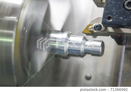 The CNC lathe machine thread cutting the metal shaft part.  71366992