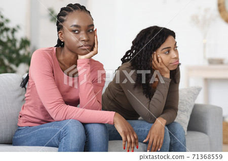 Two upset african women sitting on sofa, had quarrel Two upset african women sitting on sofa, had quarrel 71368559