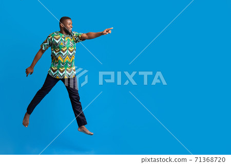 Excited black man running towards copy space for advertisement 71368720