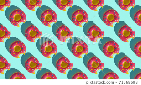 Summer tropical pattern of inflatable colorful donut, on blue background, top view, strong shadows Summer tropical pattern of inflatable colorful donut, on blue background, top view, strong shadows 71369698