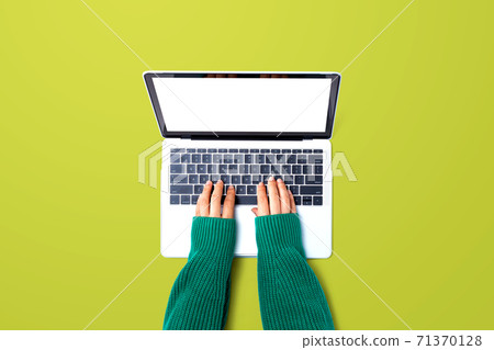 Person using a laptop computer Person using a laptop computer 71370128