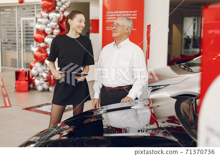 Stylish and elegant old man in a car salon Stylish and elegant old man in a car salon 71370736