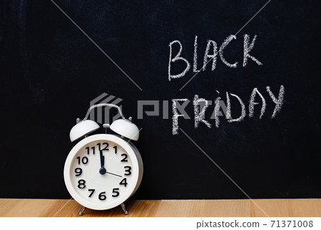 Black friday text written on blackboard and alarm clock Black friday text written on blackboard and alarm clock 71371008