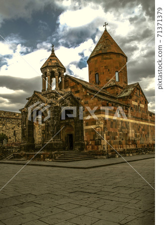 Church of the blessed Holy Virgin and bell tower rotunda in the courtyard of the fortress Khor Virap against the sky with rain clouds 71371379