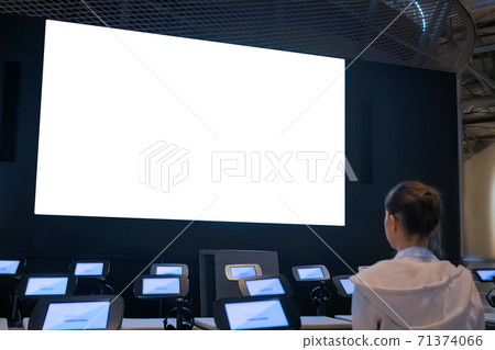 Woman looking at large blank white screen - isolated concept Woman looking at large blank white screen - isolated concept 71374066