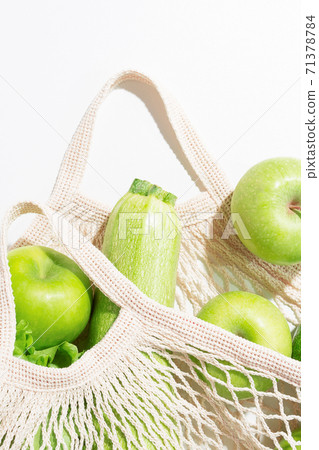 Close-up fresh green food in string bag. Close-up fresh green food in string bag. 71378784