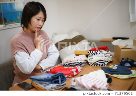 Women worried about how to dispose of children's clothes that are no longer needed 71379501