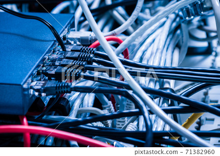 Detail of server room with bunch ethernet cables at the back of 71382960