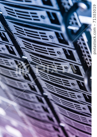 Cluster of data storage hard drives inside server room 71383019