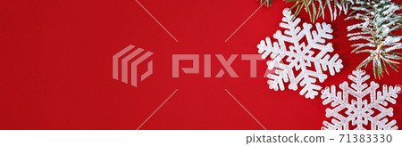 Christmas composition with white snowflake and christmas tree branch on red background, top view Christmas composition with white snowflake and christmas tree branch on red background, top view 71383330