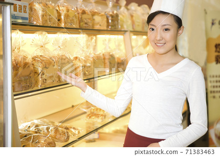 The happy bakery saleswoman is in the bakery The happy bakery saleswoman is in the bakery 71383463