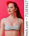 Portrain slim fit sport body young sexy woman in retro swim suit bra and red cap with clean skin beautiful creative pin-up make-up smiling looking aside isolated over pink background 71383627