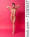 Full height body size view portrait slim busty body sexy seductive sensual beautiful woman in retro swim suit smiling looking down with hands rased isolated over pink background 71383637
