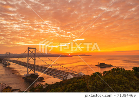 Naruto Strait and Onaruto Bridge dyed red by the sunrise 71384469
