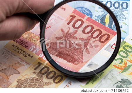 French Pacific Territories Francs in a magnifying glass 71386752