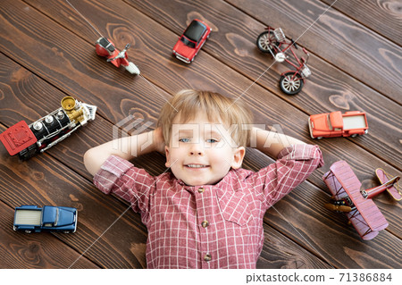 Child with vintage toys. Kid playing at home. Child with vintage toys. Kid playing at home. 71386884