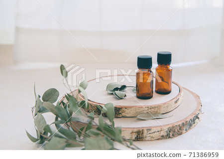 Two wood and two aroma oil bottles. Image of nature, organic and beauty. 71386959