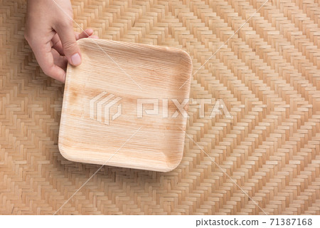 Hand holding Betel palm leaf plate (Biodegradable, Compostable or Eco friendly disposable plate) Hand holding Betel palm leaf plate (Biodegradable, Compostable or Eco friendly disposable plate) 71387168