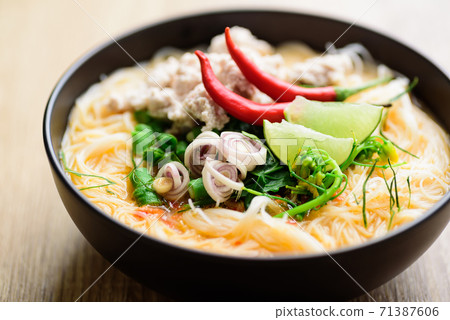 Thai food, Spicy rice noodles soup with spices and herbs (Tom Yum soup) 71387606