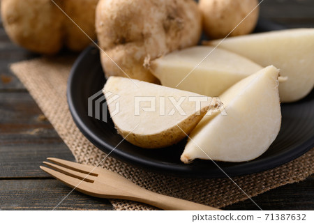 Sliced jicama or yam on plate ready to eating 71387632