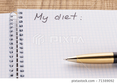 Top view workplace notebook and pen on wood table background, retro effect. Inscription - My diet. The concept of healthy eating and sports lifestyle Top view workplace notebook and pen on wood table background, retro effect. Inscription - My diet. The concept of healthy eating and sports lifestyle 71389092