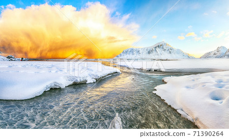 Fabulous winter scenery on Skagsanden beach with illuminated clouds during sunrise. 71390264