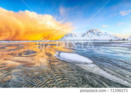 Fabulous winter scenery on Skagsanden beach with illuminated clouds during sunrise. 71390271